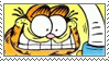 Garfield slamming down a cup of coffee with a crazed expression